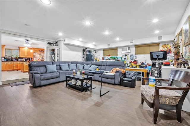 living area featuring recessed lighting, light wood finished floors, and visible vents
