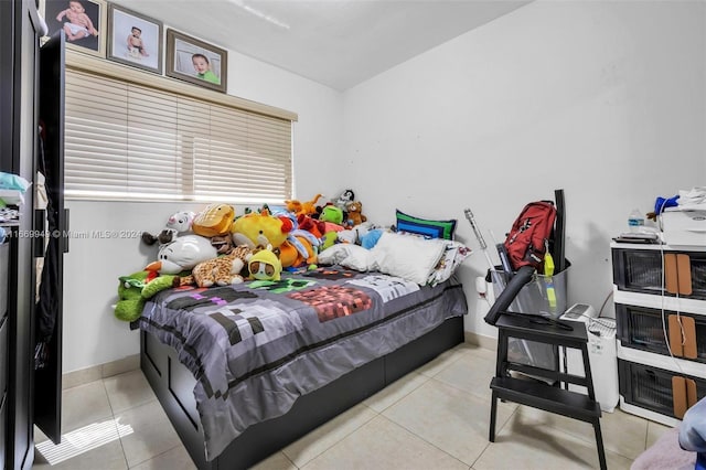 tiled bedroom featuring baseboards