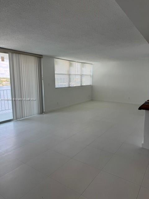 unfurnished room with a textured ceiling