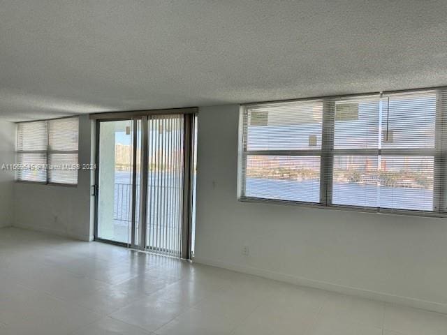 unfurnished room featuring a textured ceiling