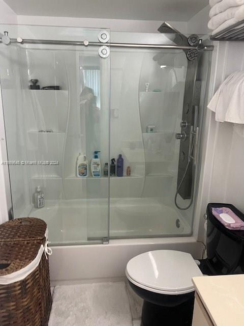 full bathroom with shower / bath combination with glass door, vanity, and toilet