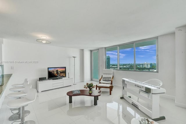 tiled living area featuring baseboards