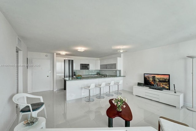 tiled living room featuring sink