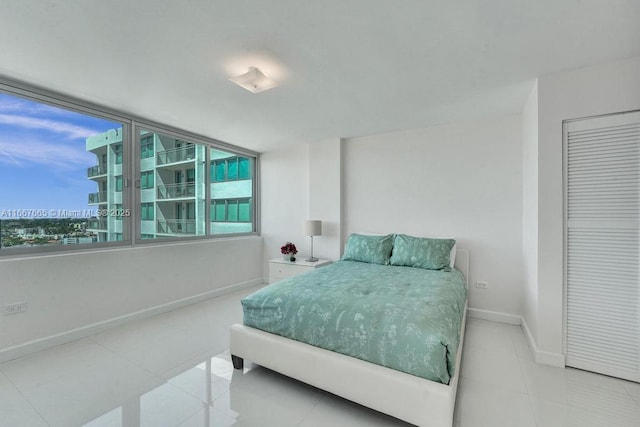 bedroom featuring baseboards and tile patterned flooring