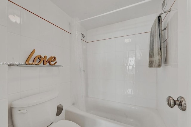 bathroom featuring toilet, tile walls, and tiled shower / bath