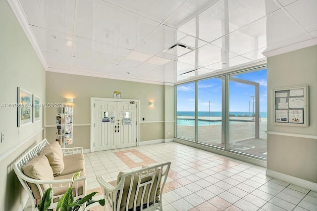 living room with baseboards, ornamental molding, tile patterned flooring, and a water view