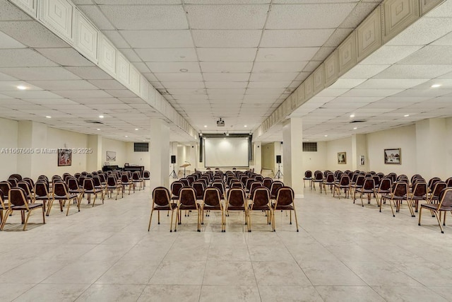 miscellaneous room featuring a paneled ceiling and light tile patterned floors
