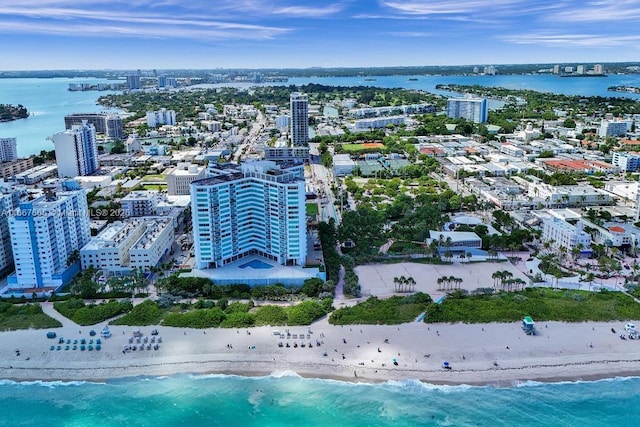 drone / aerial view featuring a water view and a view of the beach