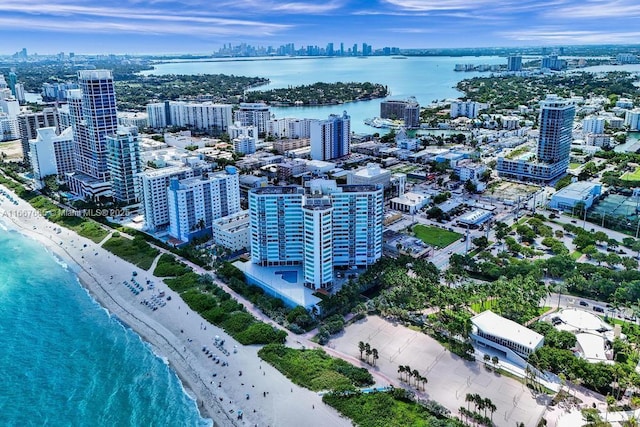 bird's eye view with a city view, a view of the beach, and a water view