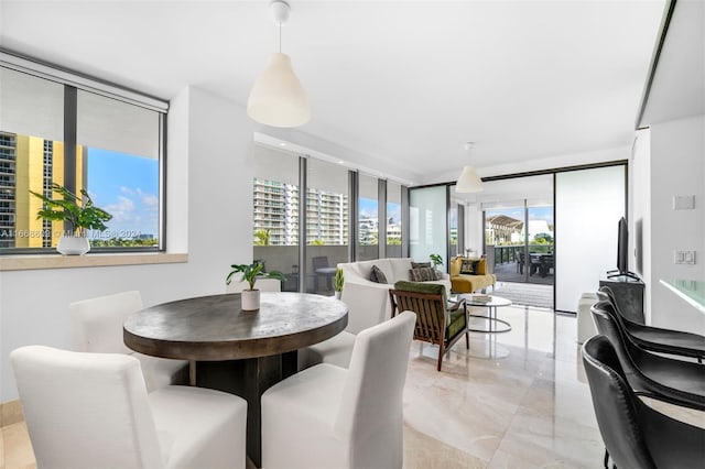 dining area with a wealth of natural light and floor to ceiling windows