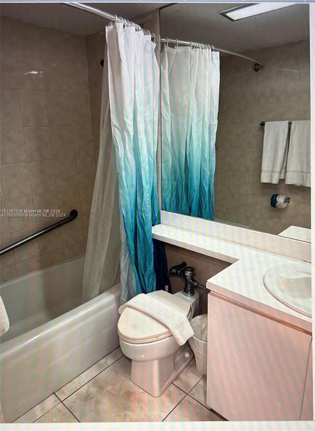 full bathroom featuring vanity, tile patterned floors, toilet, and shower / tub combo with curtain