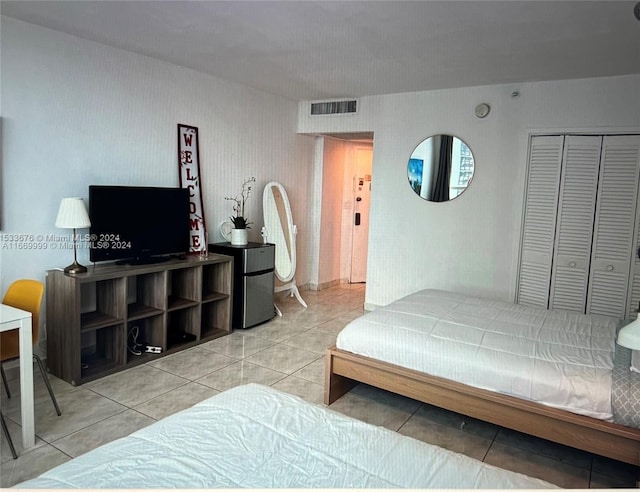 bedroom featuring light tile patterned flooring and a closet