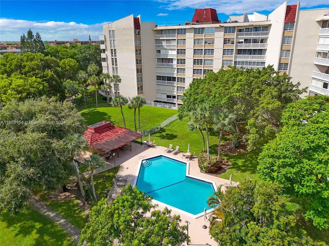 view of pool featuring a patio and a yard