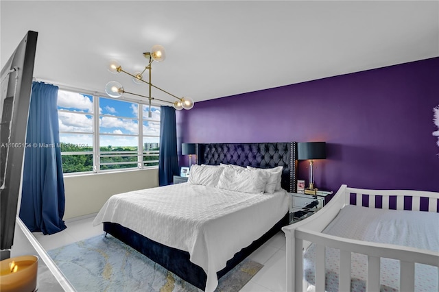 bedroom featuring light tile patterned flooring and an inviting chandelier