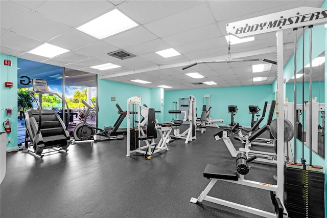 gym featuring a drop ceiling