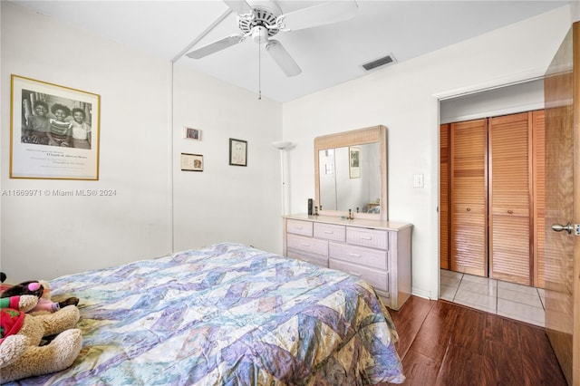 bedroom featuring a closet, wood-type flooring, and ceiling fan