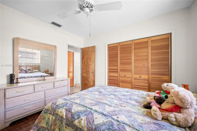 bedroom featuring dark hardwood / wood-style floors, a closet, and ceiling fan