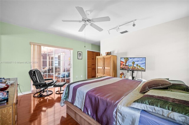 8144 SW 206th Ter, Cutler Bay, FL 33189 - bedroom featuring wood finished floors, rail lighting, ceiling fan, and baseboards
