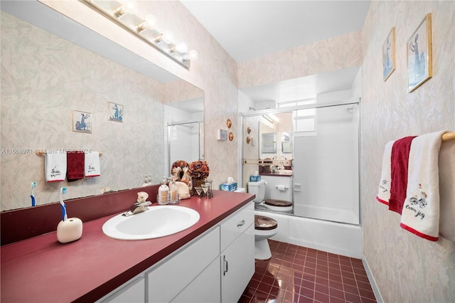 full bathroom featuring vanity, toilet, tile patterned floors, and shower / bath combination with glass door