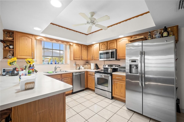 kitchen with appliances with stainless steel finishes, sink, kitchen peninsula, ceiling fan, and light tile patterned floors