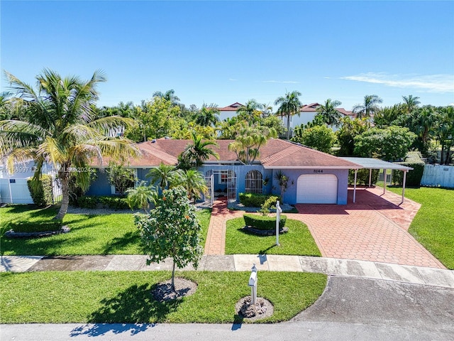 view of front of house featuring a carport, a front yard, and a garage