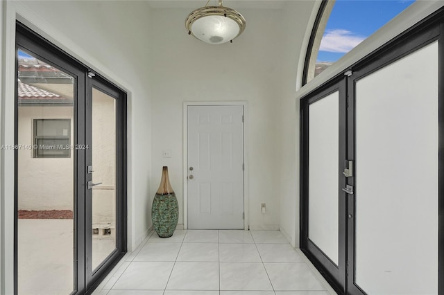 interior space with light tile patterned floors and a healthy amount of sunlight