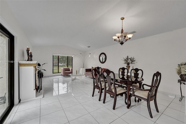 tiled dining room featuring a notable chandelier and lofted ceiling