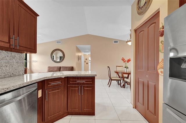 kitchen featuring appliances with stainless steel finishes, kitchen peninsula, vaulted ceiling, and light tile patterned floors