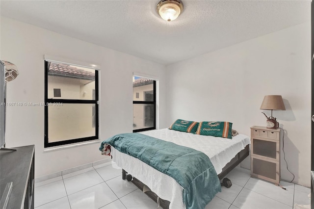 tiled bedroom with a textured ceiling