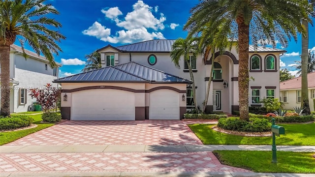 view of front of house featuring a garage and a front lawn