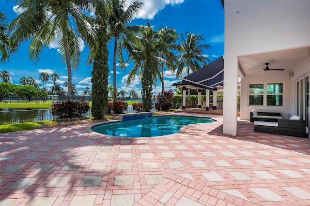 view of pool with a water view, an outdoor living space, and a patio