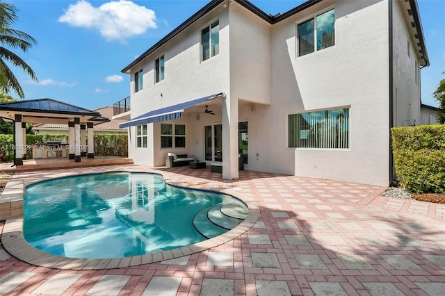 back of house featuring a gazebo, ceiling fan, an outdoor hangout area, and a patio area