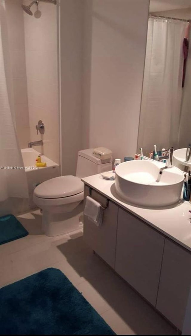 full bathroom featuring shower / bath combination with curtain, tile patterned floors, vanity, and toilet