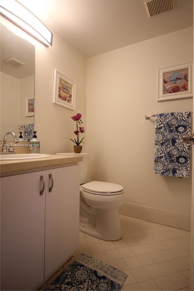 bathroom featuring vanity, toilet, and tile patterned floors