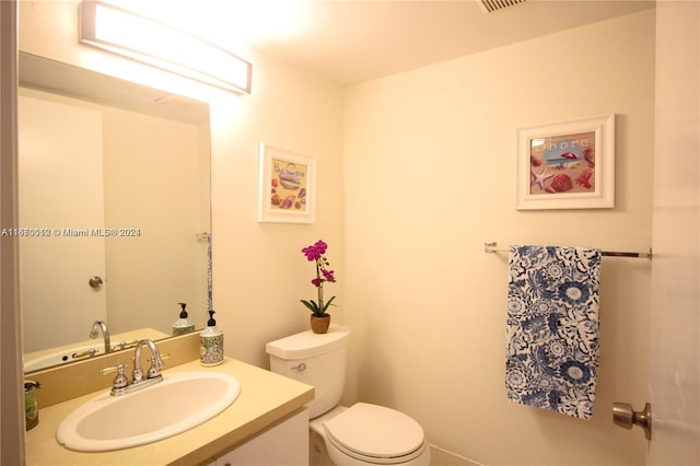 bathroom with vanity and toilet