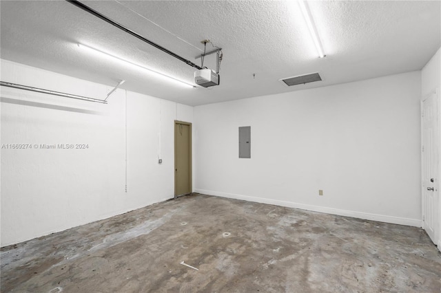 garage featuring a garage door opener and electric panel