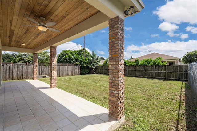 view of yard featuring ceiling fan and a patio area