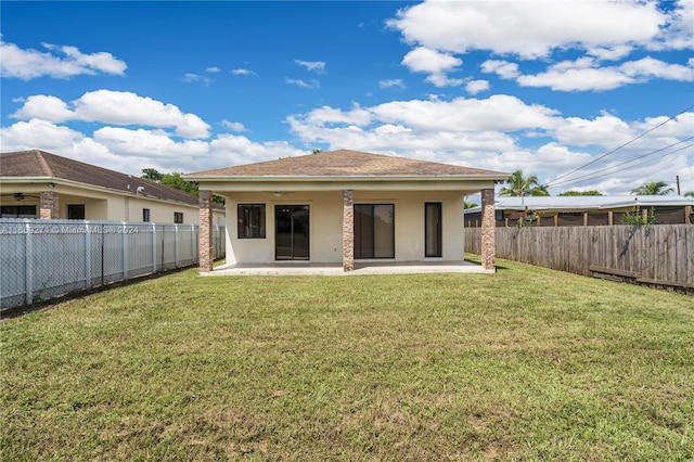 back of house featuring ceiling fan, a yard, and a patio area