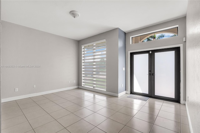 tiled entryway featuring french doors