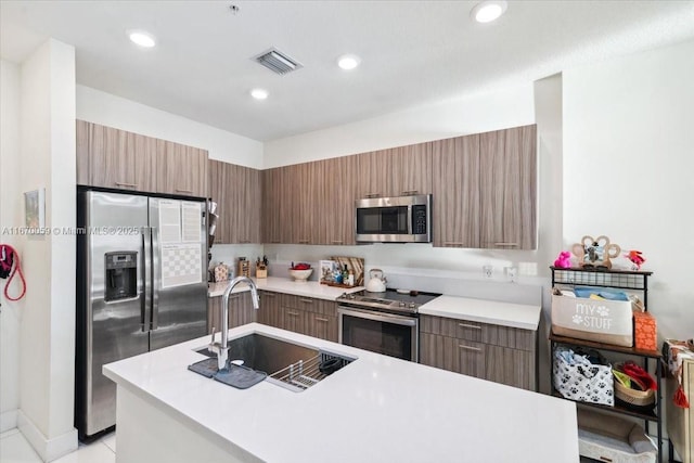 kitchen featuring light tile patterned floors, stainless steel appliances, and sink