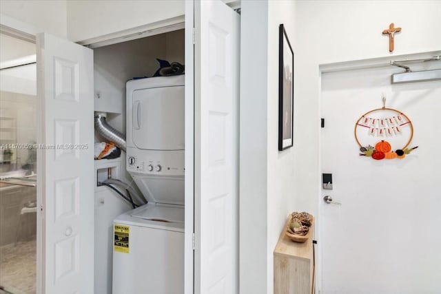 washroom featuring stacked washing maching and dryer