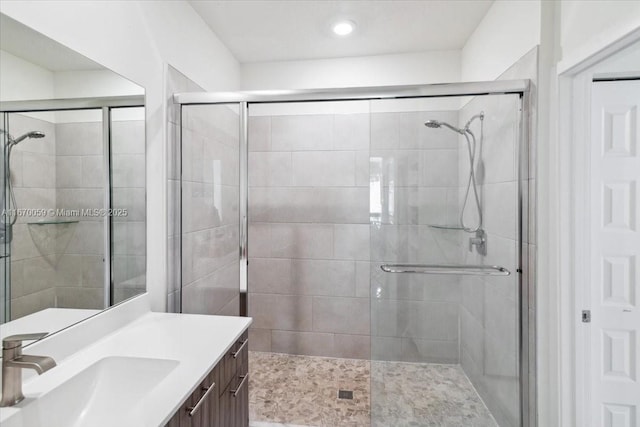 bathroom featuring vanity and an enclosed shower