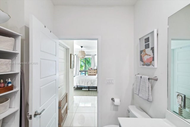 bathroom with tile patterned flooring, vanity, and toilet