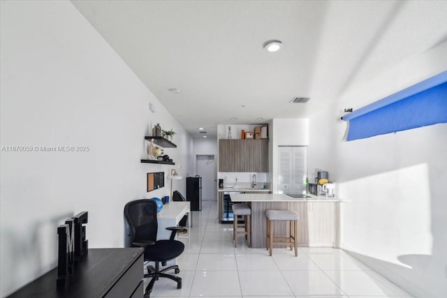 tiled home office featuring sink