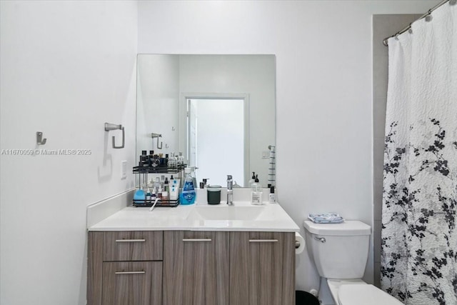 bathroom with vanity, toilet, and curtained shower