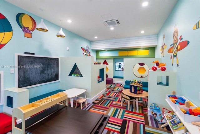 game room with dark colored carpet