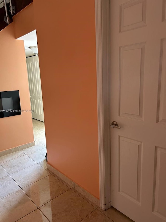 corridor with light tile patterned floors