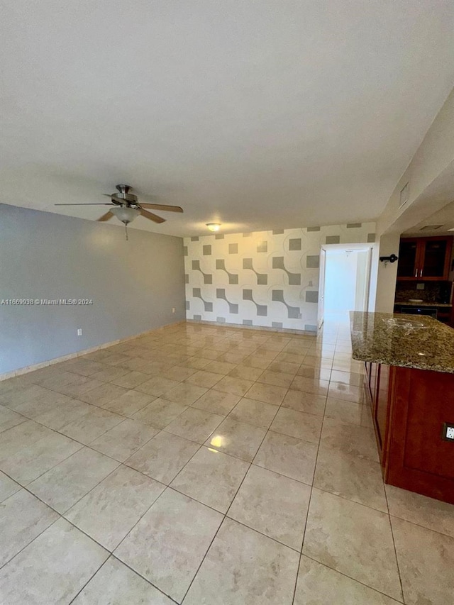 unfurnished room with ceiling fan and light tile patterned flooring