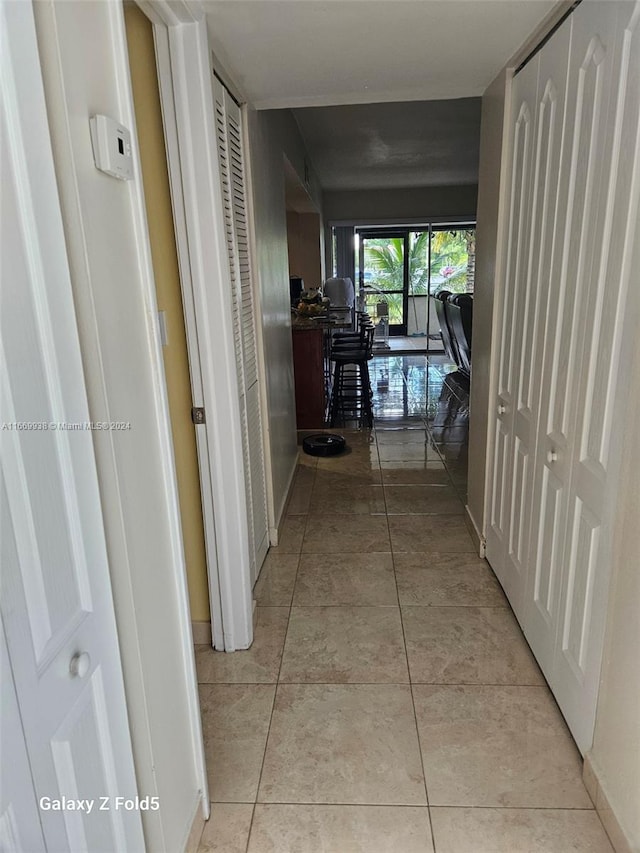 hallway with light tile patterned floors