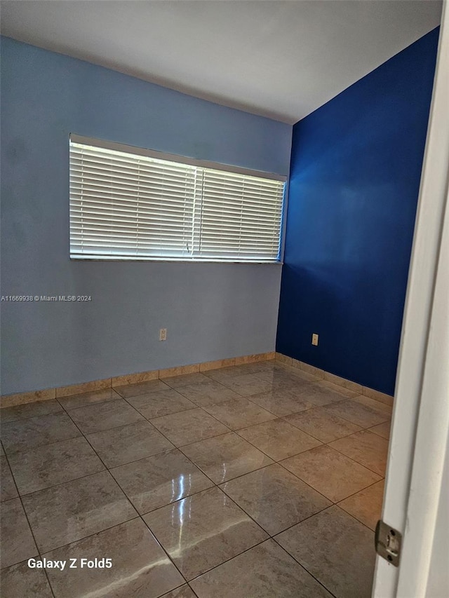 unfurnished room featuring tile patterned floors